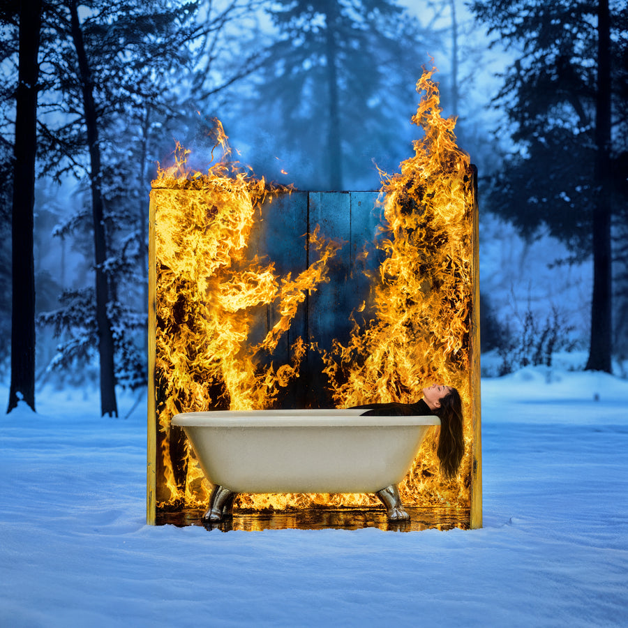 The Girl Who Burned, a bathtub in the snow before a wall of fire