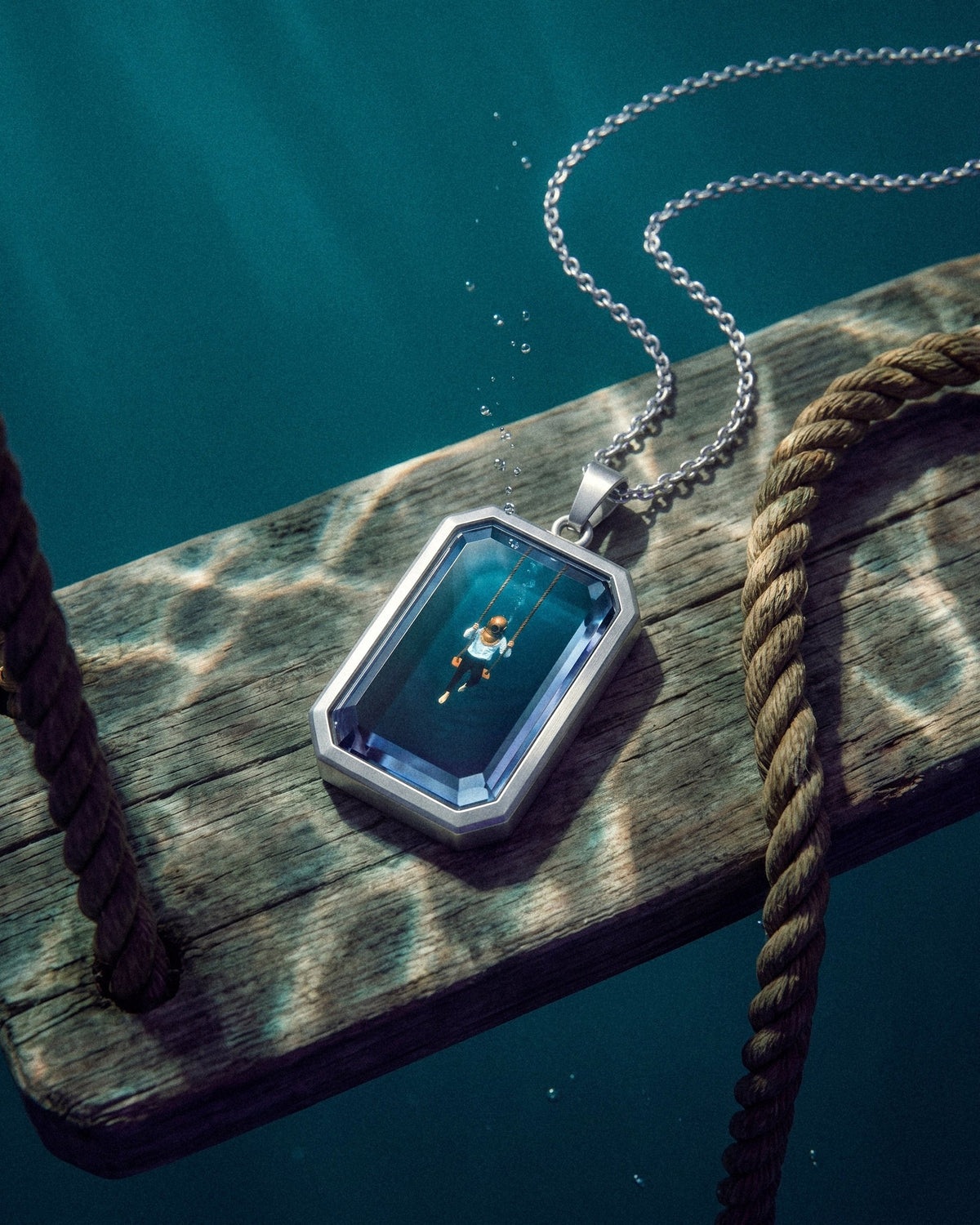 The Observer, the Amulet by Mirrors by Viulet, deep teal water, on the swing