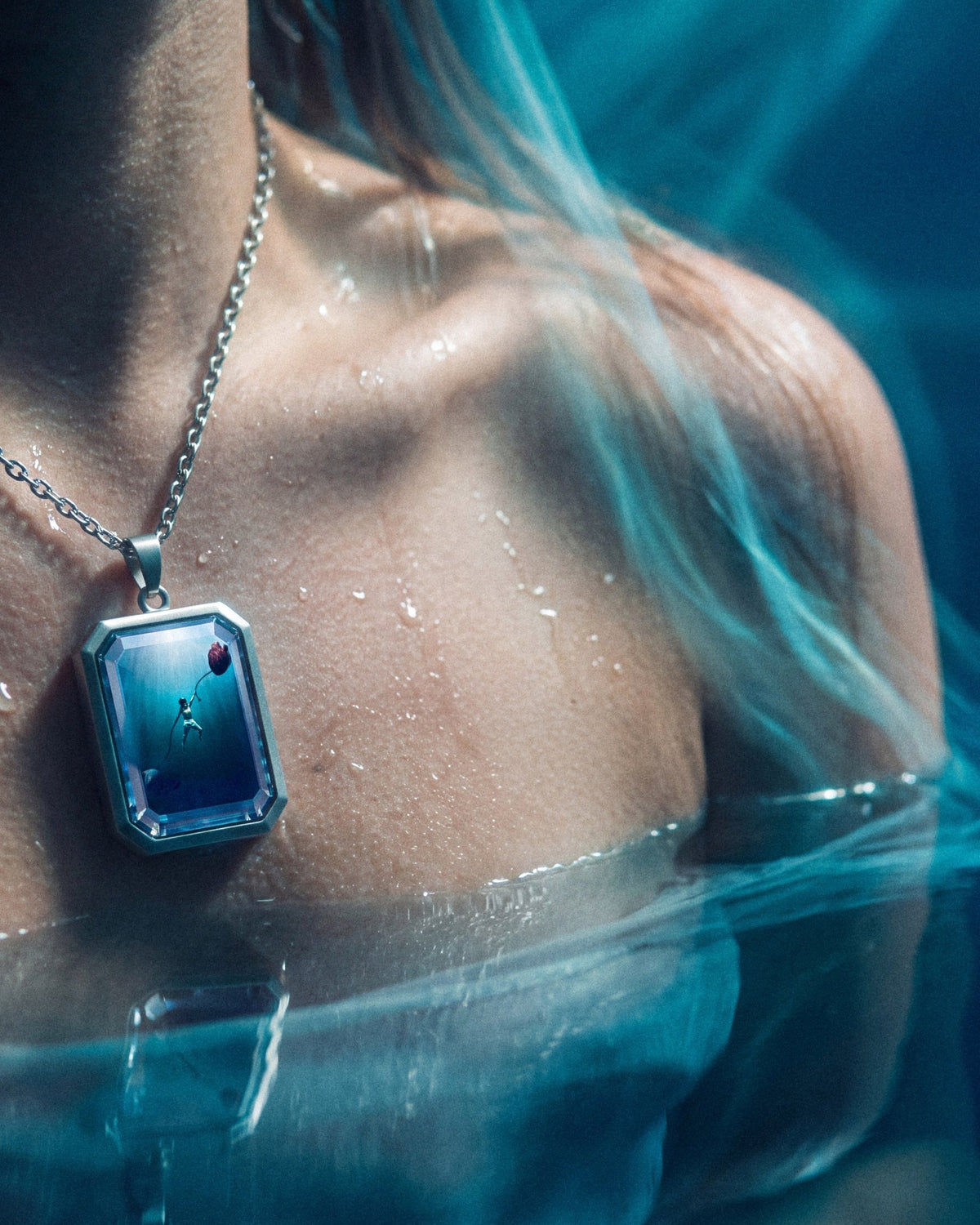 The War Within, the Amulet by Mirrors by Viulet, in the water, wet skin, worn, the artwork facing out
