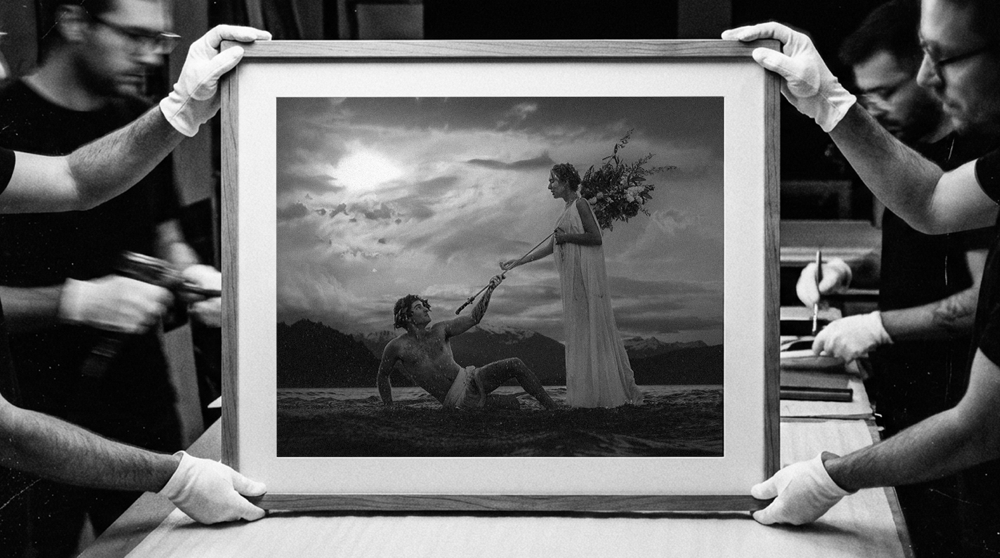 The Courage of The Coward, framed, held by gloved hands in the Atelier