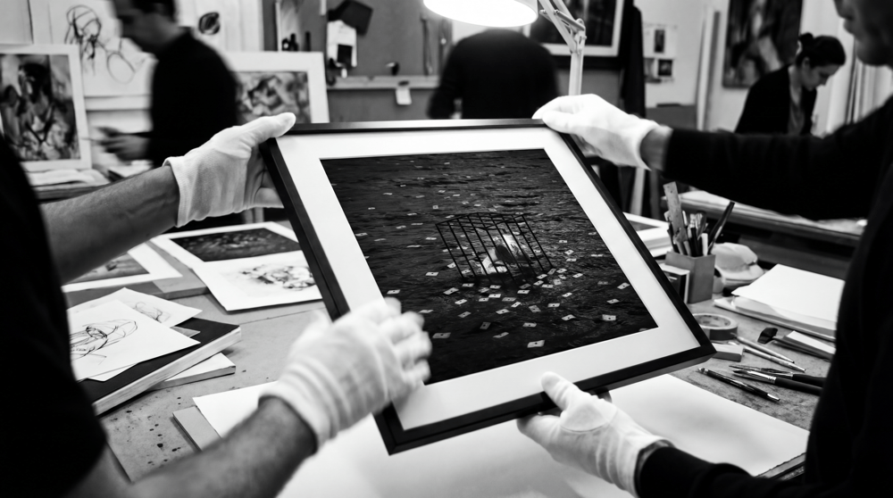 Letters To The Subconscious, B&W Edition, framed, held by gloved hands in the Atelier