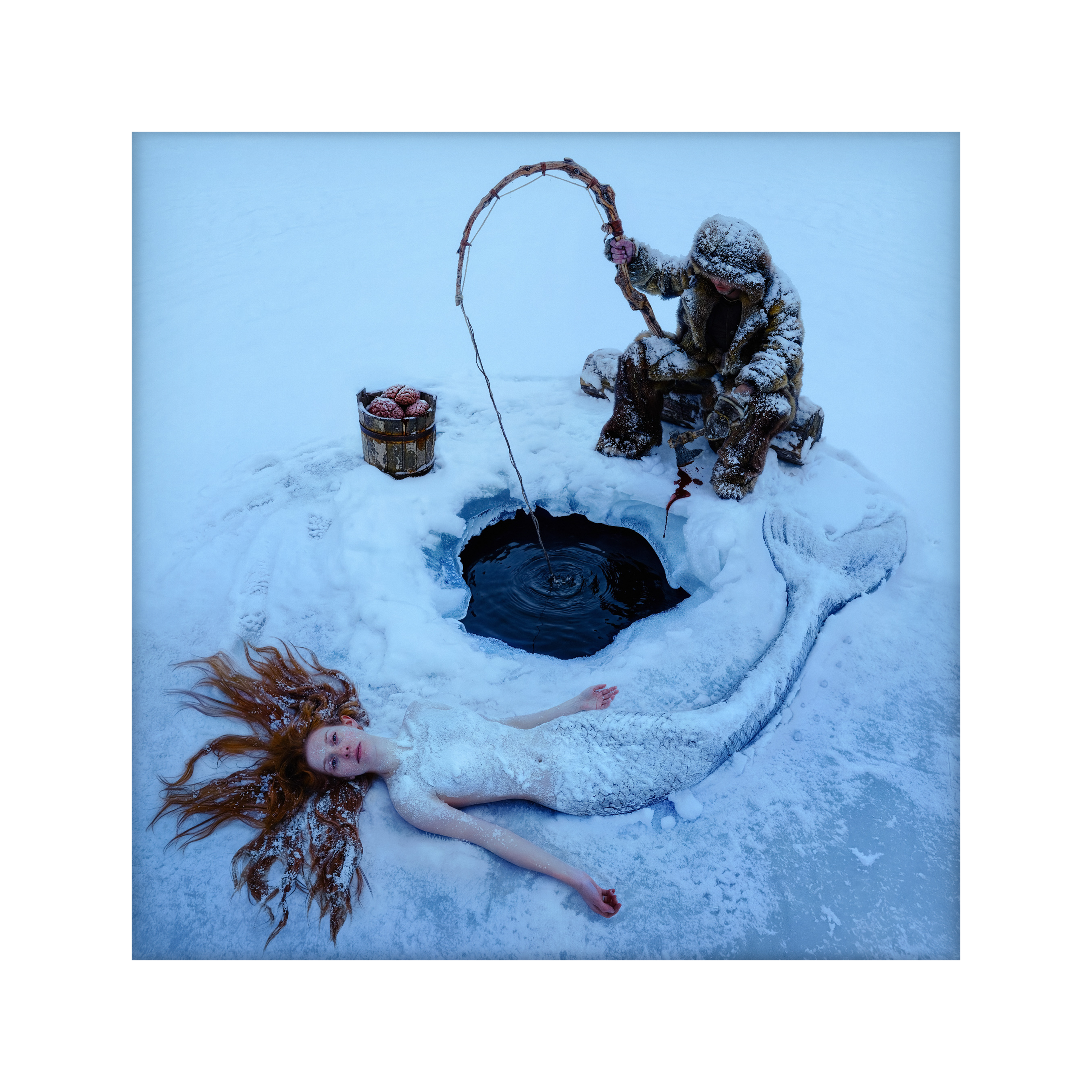Dreamfisher, a fisherman over a hole in the ice and a mermaid on the snow
