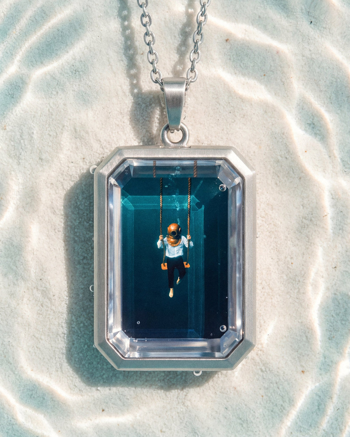The Observer, the Amulet by Mirrors by Viulet, the Amulet large in its own world, silver, clear teal water