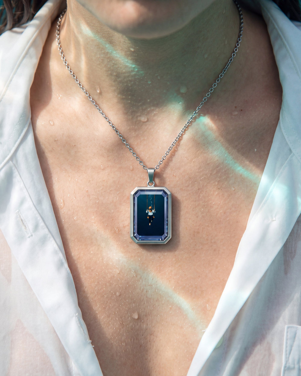 The Observer, the Amulet by Mirrors by Viulet, wet white shirt, teal light, worn, the artwork facing out