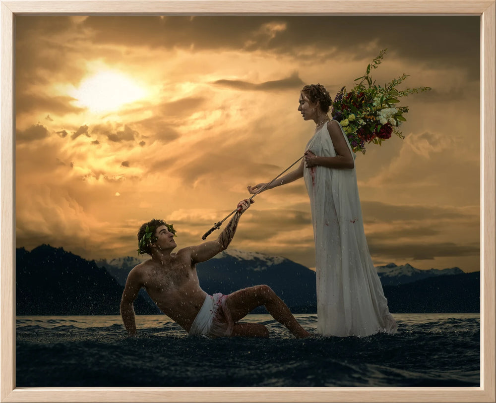 A standing woman reaches toward a seated man beneath a glowing evening sky, presented Lined in Atelier Wood