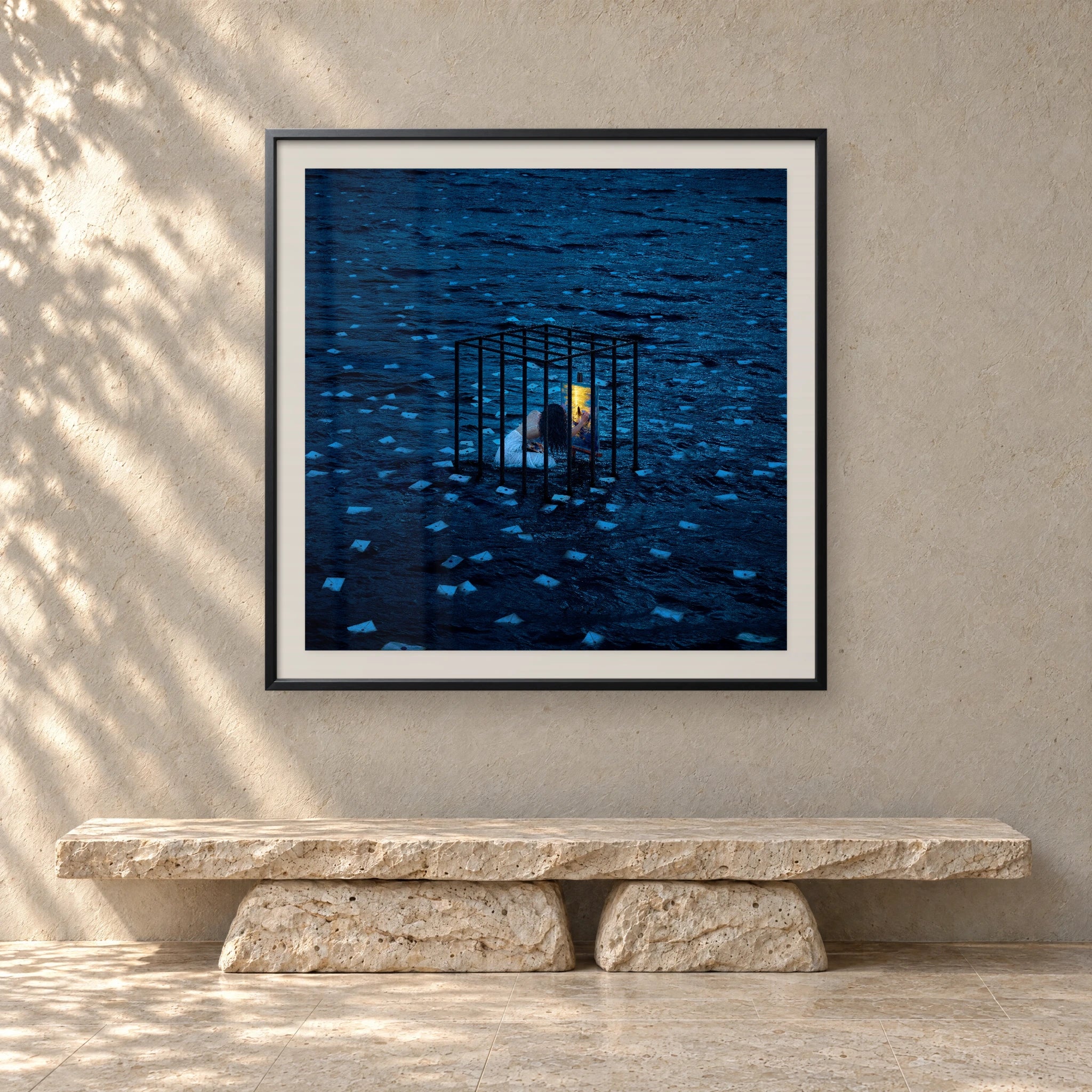 Letters in a sunlit room above a travertine bench
